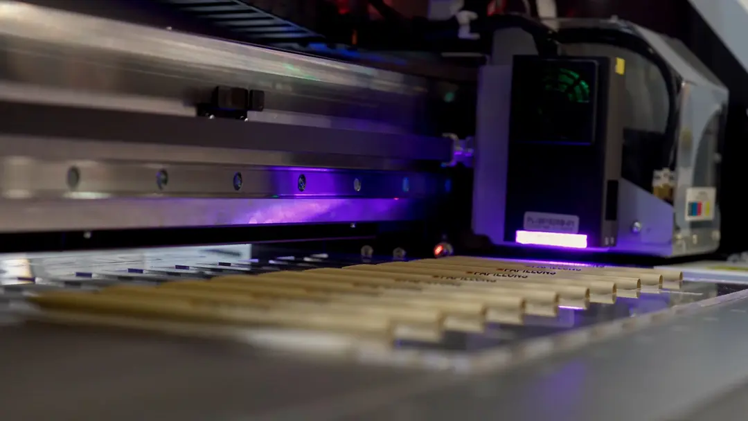 A UV printer in action, printing a vibrant design on a mug, showcasing impactful creative printing by DPN Printing in their workshop.